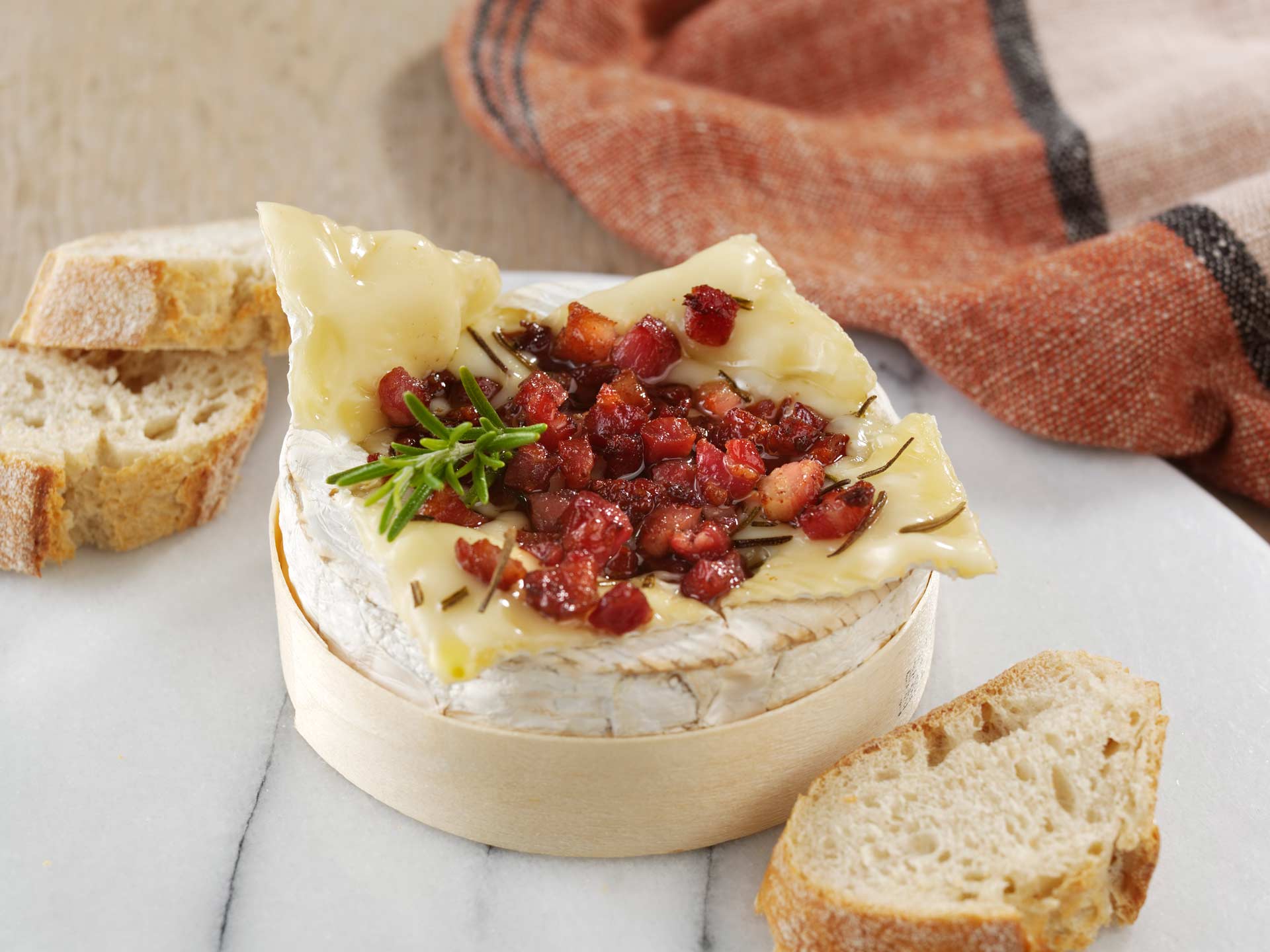 A baked camembert with pancetta and rosemary