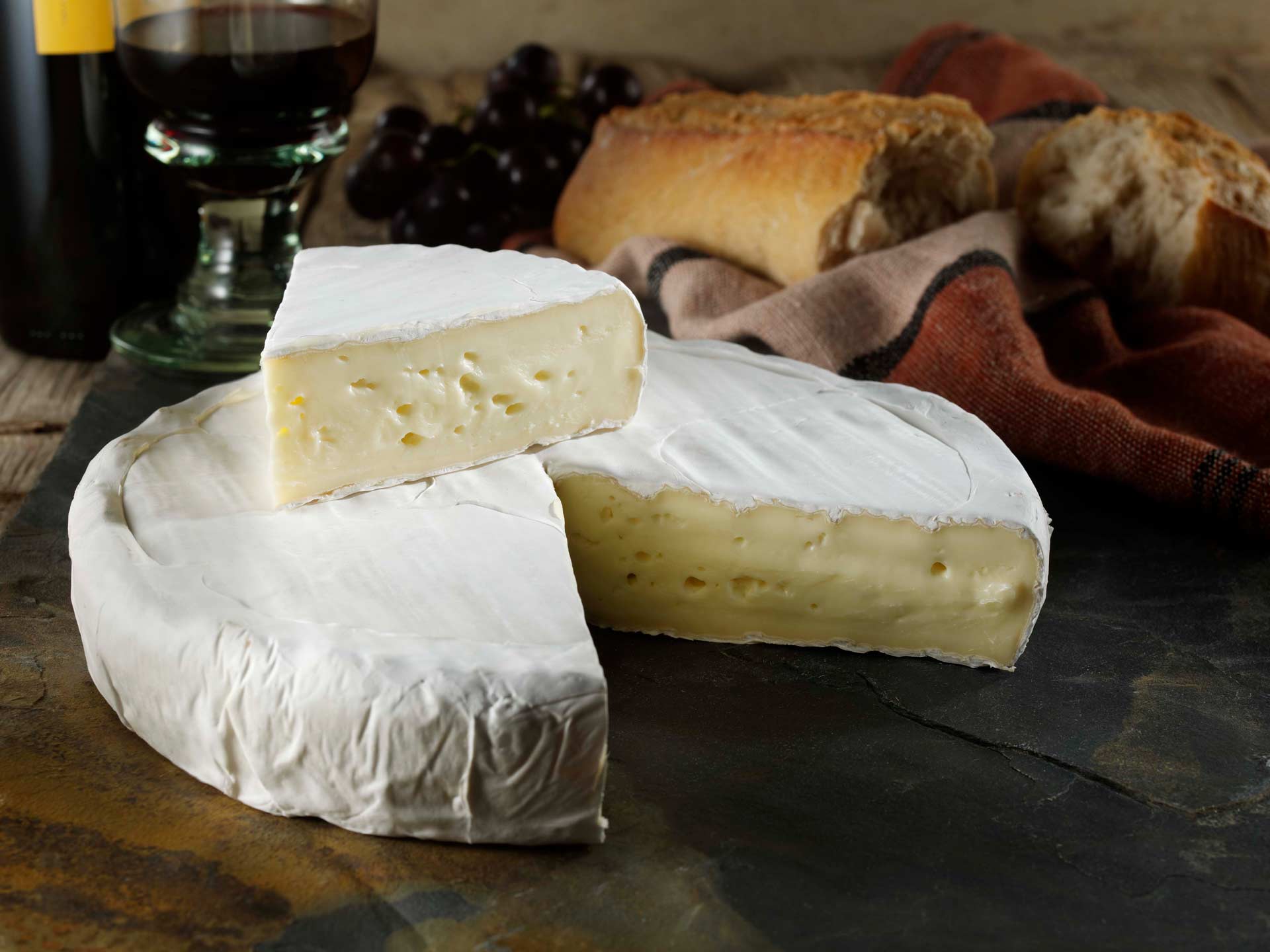 A brie wheel with a wedge cut out of it